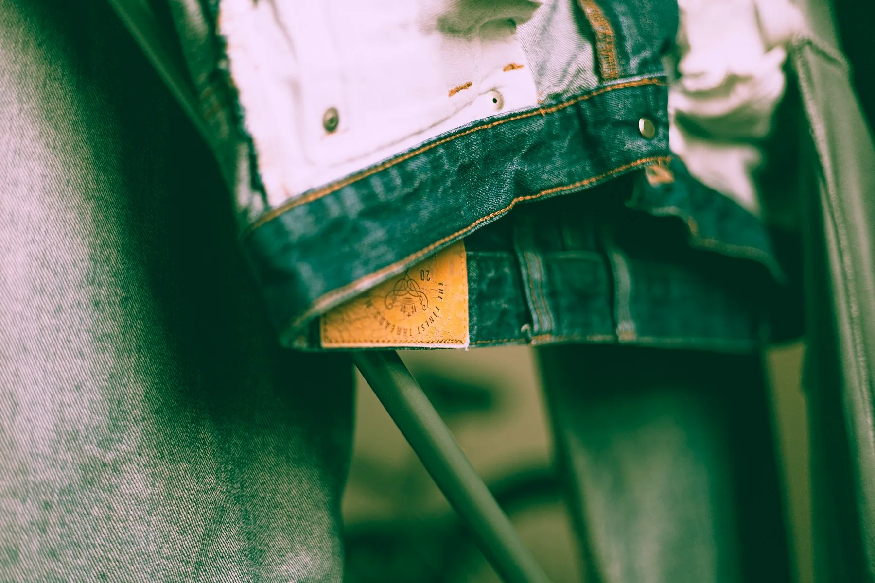 Close view of a worn label stitched inside a denim garment