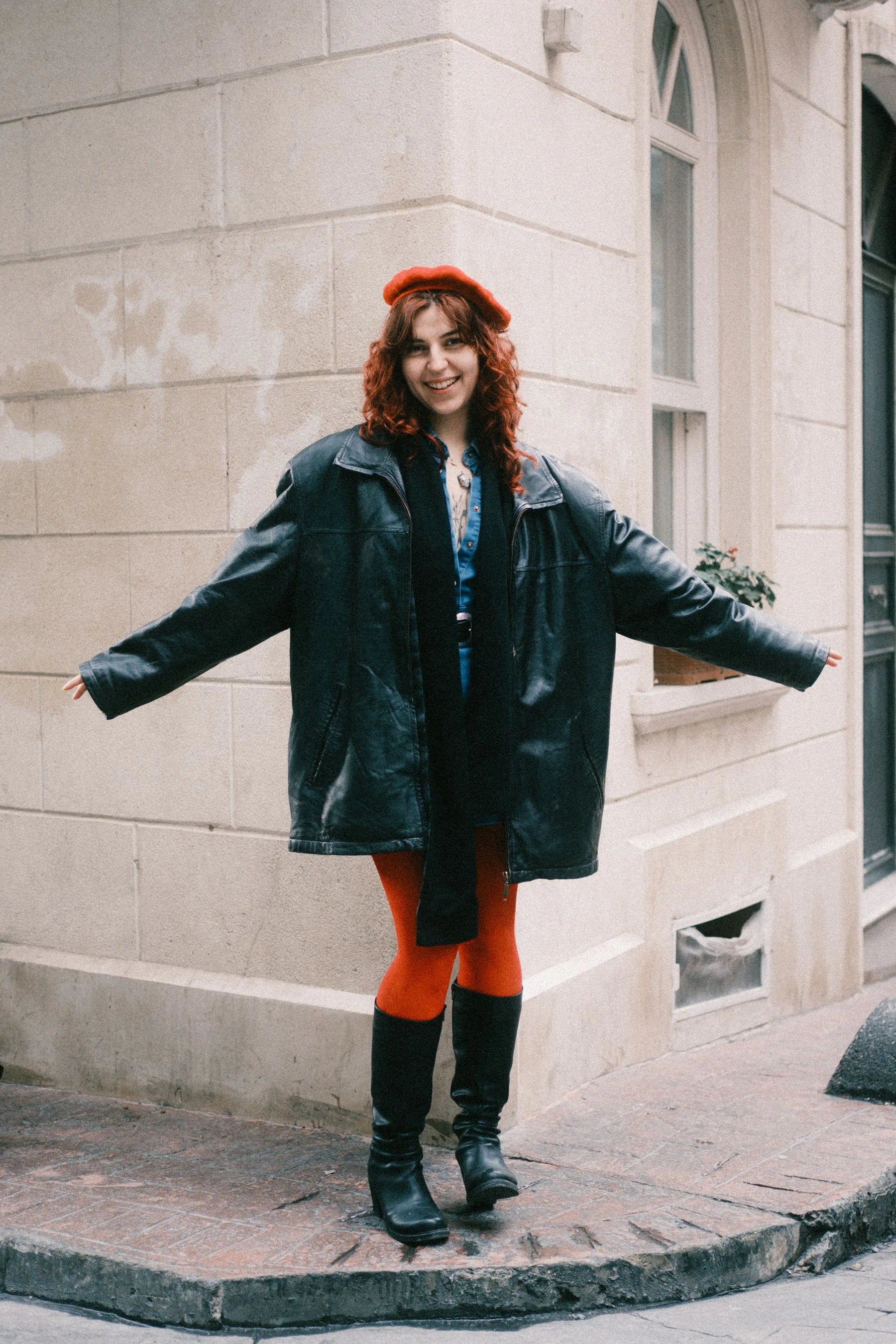 Woman wearing a dark vintage jacket on a city street